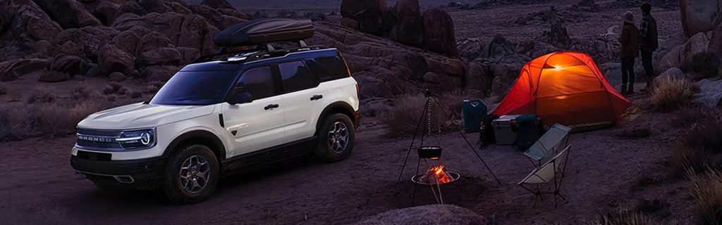 White 2024 Ford Bronco with Couple Camping