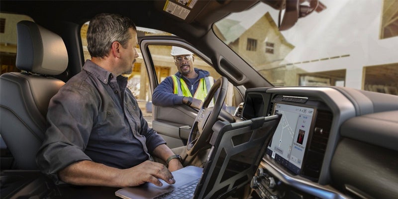 2024 Ford F-150 and a man on a laptop